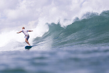 Indonesia, Bali, man surfing on a wave - KNTF00752