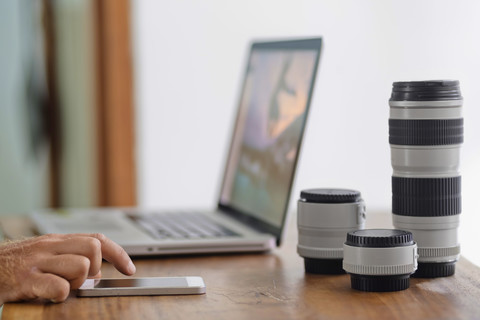 Photographer working on desk at home stock photo