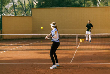 Teenage girl training tennis with her teacher - VABF01265