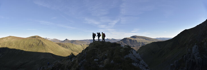 UK, North Wales, Snowdonia, Nantlle Ridge, silhouette of three mountaineers - ALRF00848