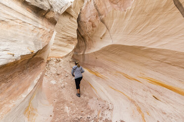 USA, Paria Canyon, Vermillion Cliffs, Page, tourist inside rock formation Nautilus - FOF09037