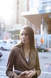 USA, New York, Manhattan, portrait of serious young businesswoman with tablet - BOYF00714