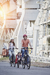 Deutschland, Hamburg, Familie fährt E-Bikes am Hafen - RORF00698