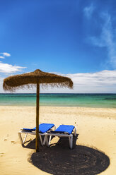 Spain, Menorca, Son Bou, beach with sunshade and sun loungers - SMAF00710