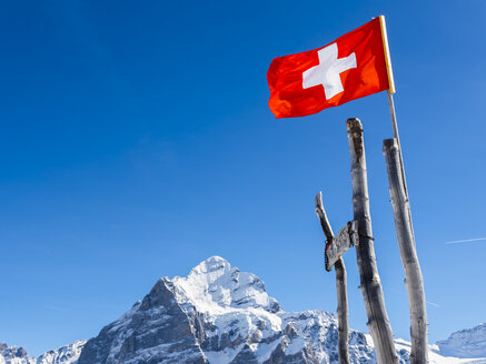 Switzerland, Canton of Bern, Grindelwald, Swiss flag in the mountains - AMF05354