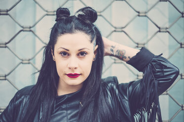 Portrait of dark-haired young woman with black leather jacket and tattoos - SIPF01481