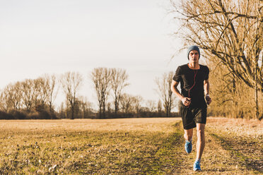 Man running in rural landscape - UUF10208