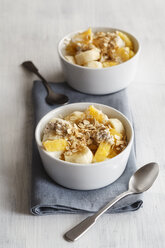 Bowl of granola with oat flakes, natural yoghurt, ananas and banana - EVGF03123