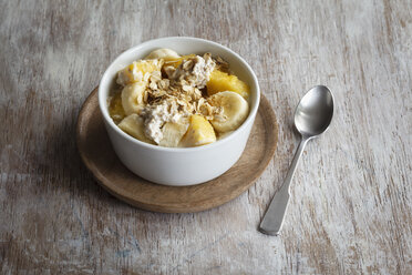 Bowl of granola with oat flakes, natural yoghurt, ananas and banana - EVGF03124