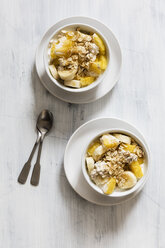 Bowl of granola with oat flakes, natural yoghurt, ananas and banana - EVGF03125