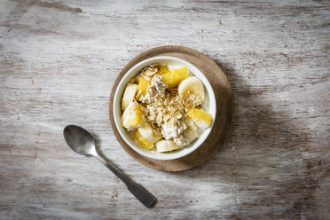 Bowl of granola with oat flakes, natural yoghurt, ananas and banana - EVGF03126