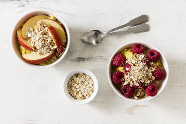 Bowl of porridge with raspberries and bowl of porridge with apples - EVGF03136