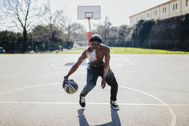 Barechested basketball player in action on court - GIOF02473