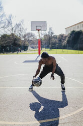 Barechested basketball player in action on court - GIOF02474