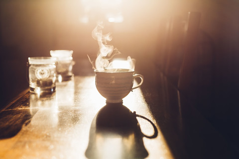 Hot cup of tea in the morning light stock photo