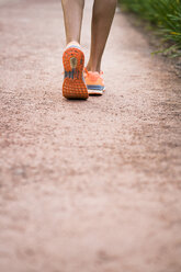 Close-up of running woman - KKAF00536