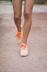 Close-up of running woman - KKAF00537