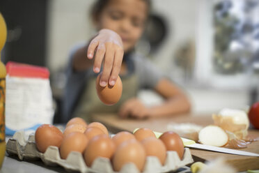 Girl in kitchen taking egg - ZEF13207