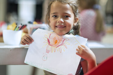 Smiling girl showing drawing - ZEF13216