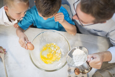 Father and two boys baking in kitchen - ZEF13220