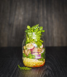 Preserving jar of buckwheat salad with vegetables, coconut chips and diced Striploin Steak - KSWF01795
