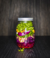 Preserving jar of salad with vegetables and salmon - KSWF01799