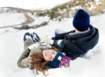 Junges Paar im Schnee liegend - MGOF03145