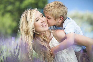 Happy mother with son in lavender field - ZEF13234