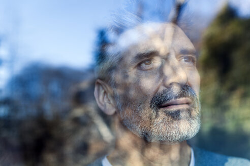 Mature man looking out of window - TCF05352