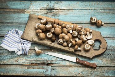 Crimini mushrooms on wooden chopping board - MAEF12187