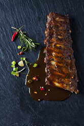 Marinated and grilled spare ribs with Barbecue sauce on slate - CSF28219