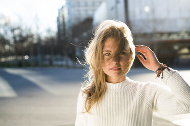 Portrait of smiling woman with blowing hair - KKAF00541