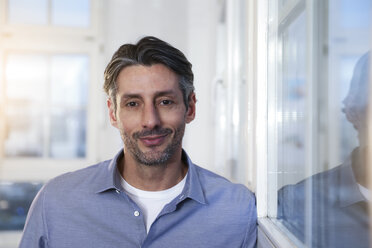 Portrait of smiling man in office - FKF02227