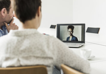 Business people having a video conference in office - UUF10275