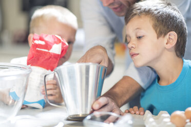 Boy helping to cook in kitchen - ZEF13306