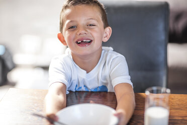 Porträt eines lächelnden Jungen am Esstisch - ZEF13429