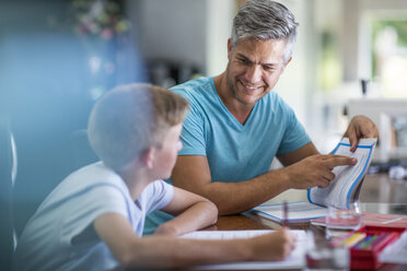 Father helping son doing homework - ZEF13467