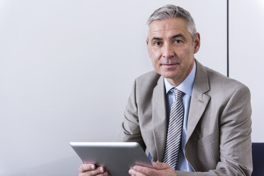 Porträt eines reifen Geschäftsmannes, der ein digitales Tablet benutzt - DIGF01556