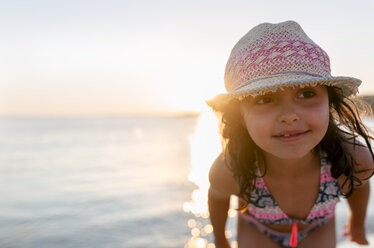 Spain, Menorca, girl on the beach at sunset - MGOF03174