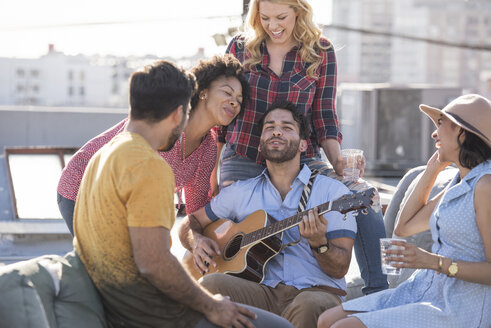 Freunde feiern eine Dachterrassenparty und spielen Gitarre - WESTF22854