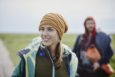 Smiling woman with man in background on a trip - RORF00738