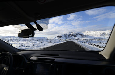 Iceland, road and snow-capped mountain seen from inside car - RAEF01785