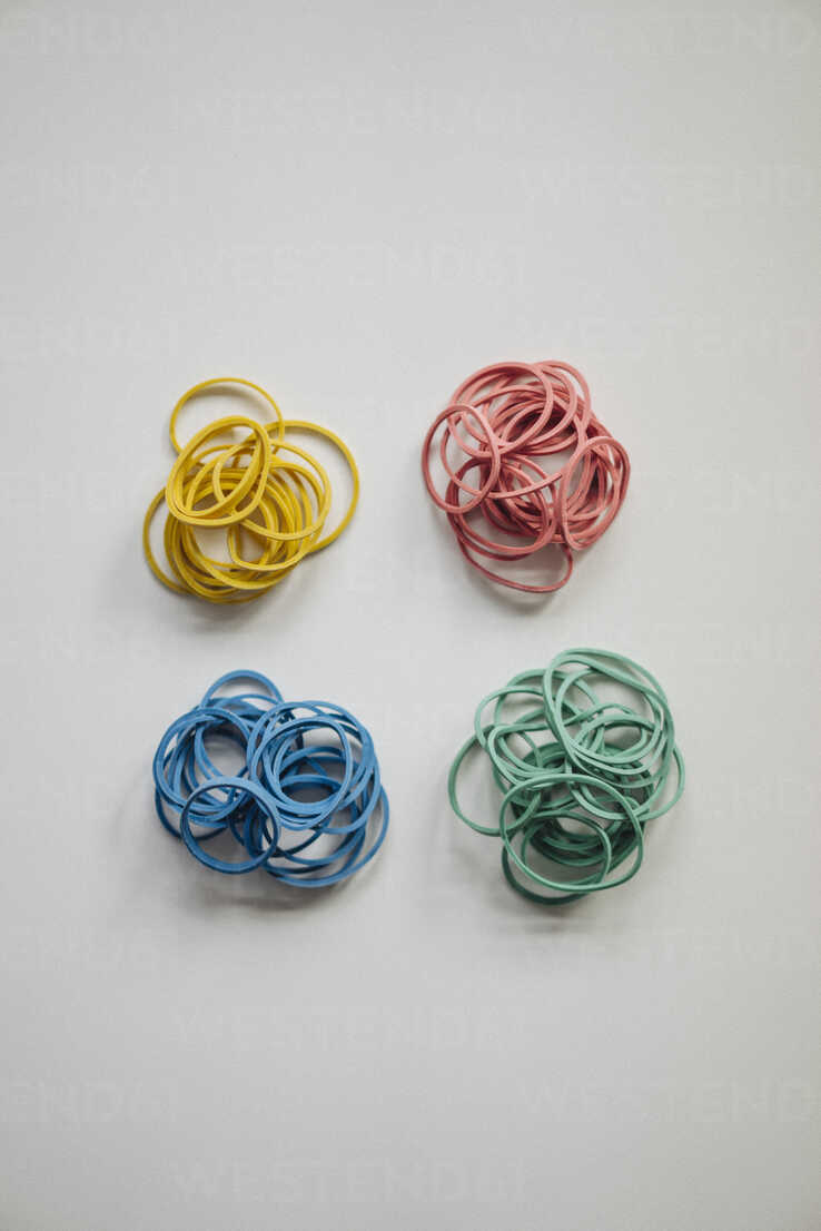 Piles of multicolored rubber bands stock photo