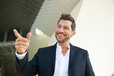 Portrait of confident businessman outdoors pointing his finger - CHAF01846