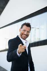 Portrait of confident businessman outdoors pointing his finger - CHAF01861