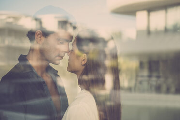 Young couple in love behind windowpane - SIPF01532