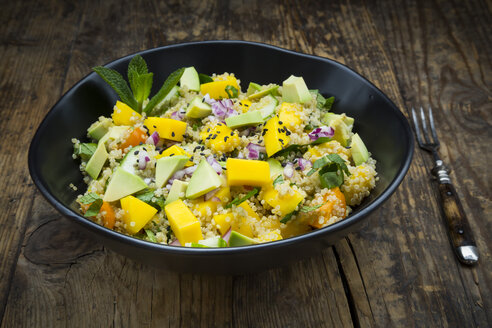 Bowl of quinoa salad with mango, avocado, tomatoes, cucumber, herbs and black sesame - LVF05986