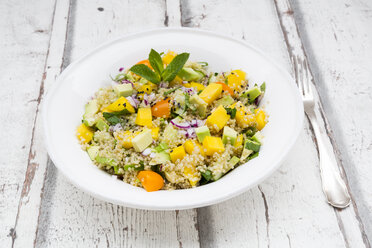 Plate of quinoa salad with mango, avocado, tomatoes, cucumber, herbs and black sesame - LVF05988