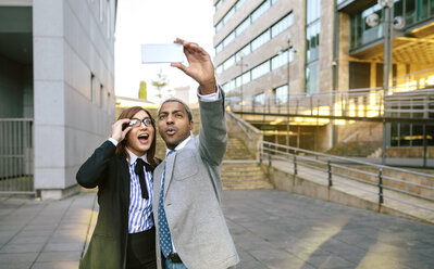 Young businessman and woman taking smart phone pictures - DAPF00635