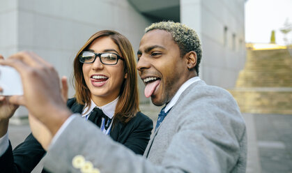 Young businessman and woman taking smart phone pictures - DAPF00636